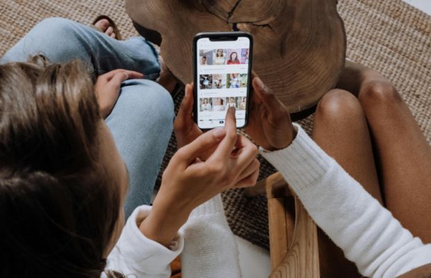 Woman engaging with social media on her mobile device, representing community growth