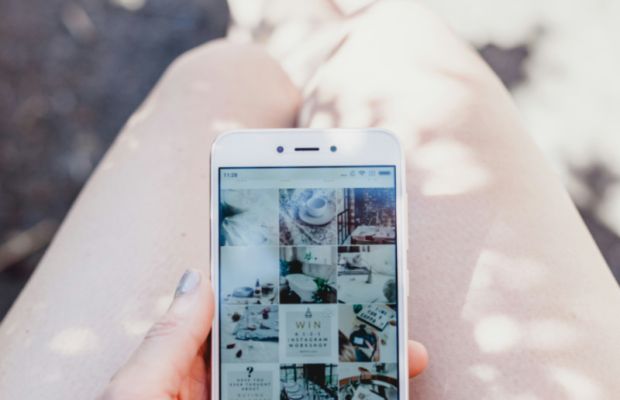 Woman viewing social media on her smartphone during content strategy planning
